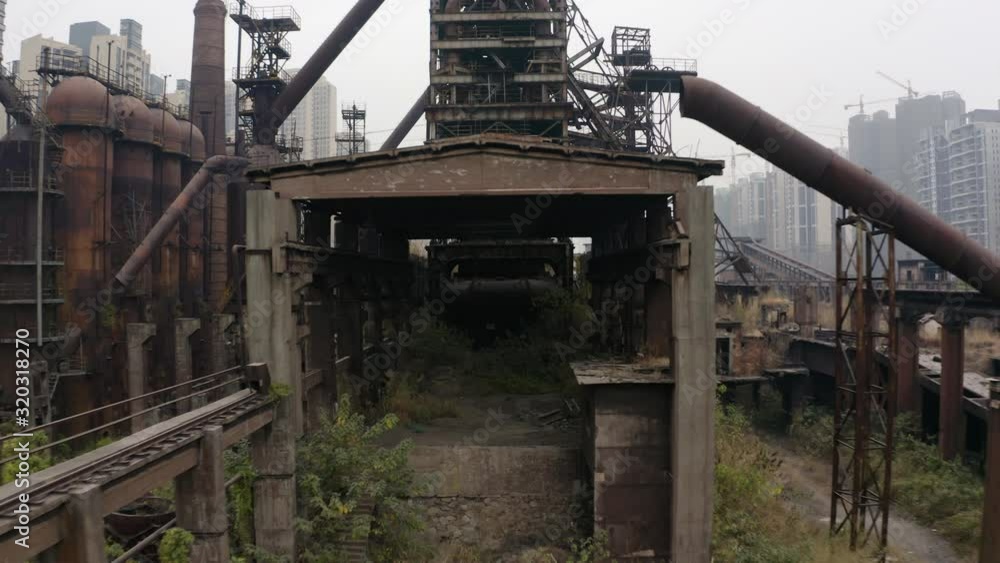 Abandoned steel factory mill in between living apartment blocks, Guangzhou, China, Aerial shot. Abandoned steel factory mill in between living apartment blocks, Guangzhou, China, Aerial shot.