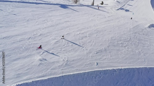 Aerial Shot of Skiers Coming Down the Slope.
Overview of Skiers Going Downhill from Snowy Slope.