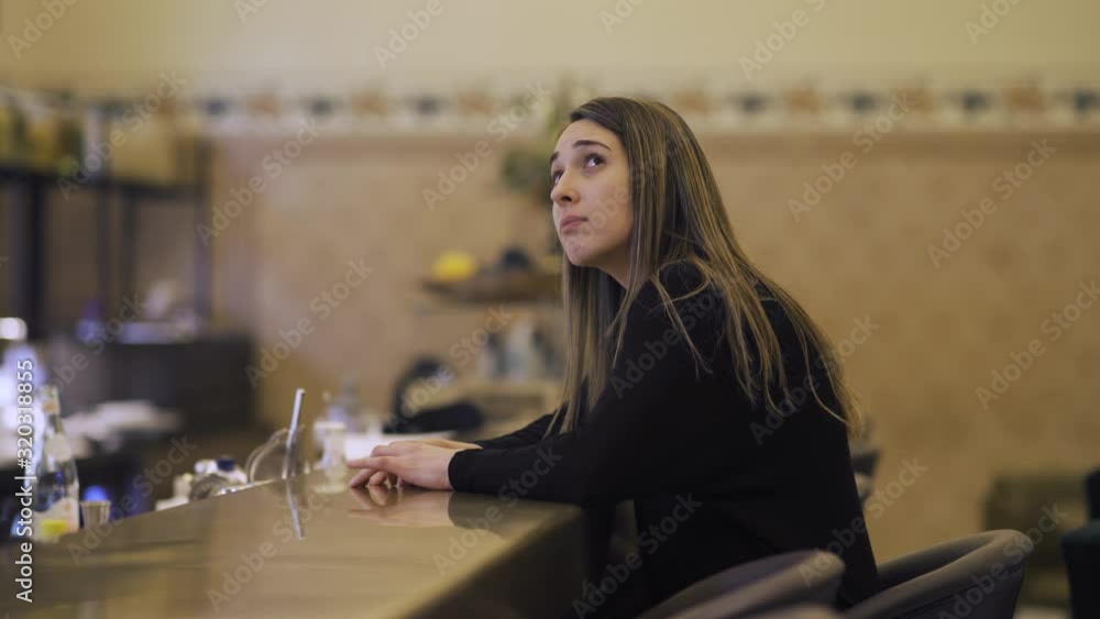 A blond sad woman waiting impatiently for her date to arrive at a bar. 4K A blond sad woman waiting impatiently for her date to arrive at a bar. 4K