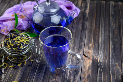 Cup and teapot butterfly pea flower blue tea. Healthy detox herbal drink.