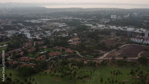 Acapulco Bay in Twilight, Aerial View of Apartment Buildings Comples With Pacific Ocean in Background photo