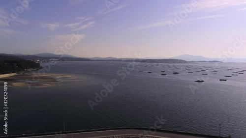 Coast of A Pobra do Caraminal with mussels banks. Aerial pan left photo