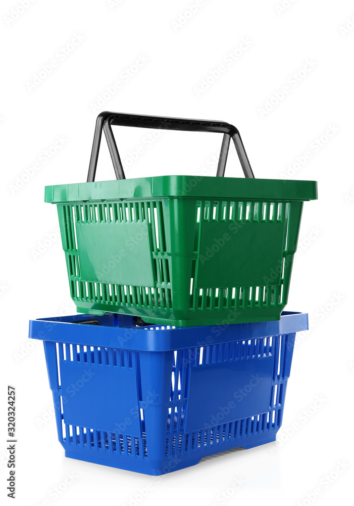 Fototapeta premium Color plastic shopping baskets isolated on white