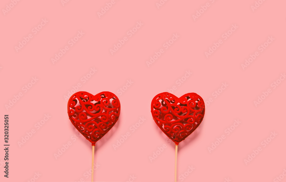 Abstract composition with two decorative hearts on pink paper background. Valentine day theme.