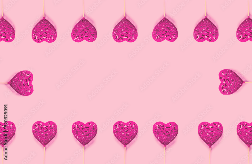 Abstract composition with decorative hearts on pink paper background. Valentine day theme.