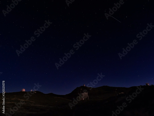 Night astrophotography, sky with stars at Roque de los Muchachos with telescopes of astronomical observatory, la Palma, Canary islands, Spain photo