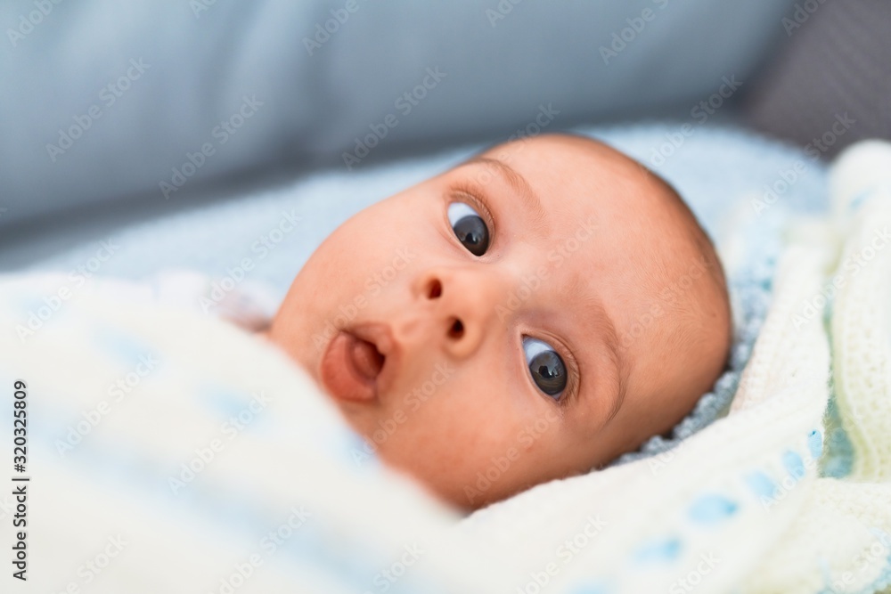 Adorable baby lying down on the sofa at home. Newborn relaxing and resting comfortable Adorable baby lying down on the sofa at home. Newborn relaxing and resting comfortable