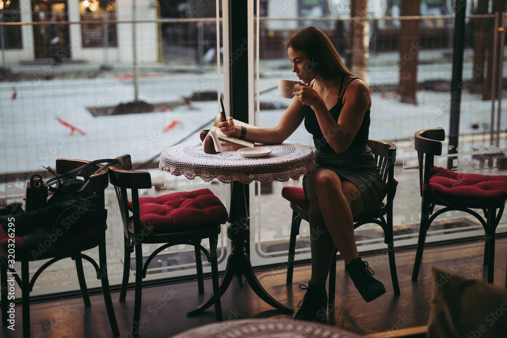 Woman playing with smartphone in cafe Woman playing with smartphone in cafe