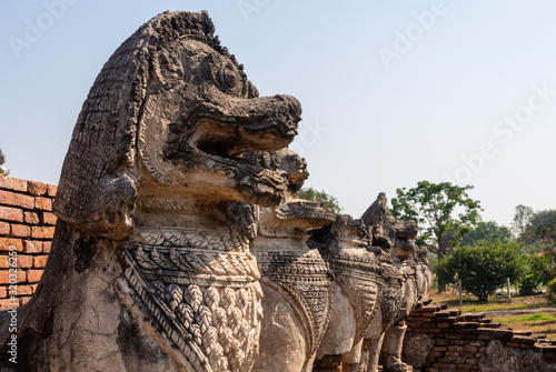 Old Thai lion statue in front of an abandoned temple in Ayutthaya