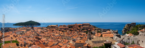 A Panoramic photograph showing the UNESCO World Heritage Site Dubrovnik, Croatia. A number of terracotta roof tops lead the viewer towards the Adriatic sea and nearby Lokrum Island.
