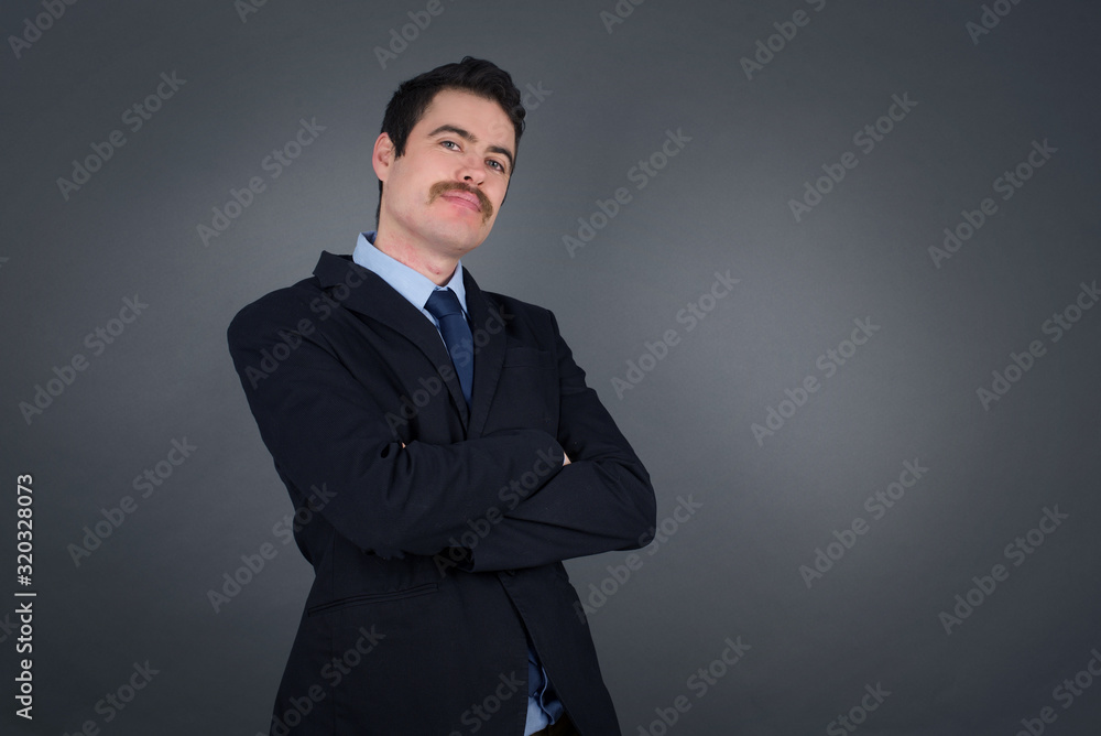 Waist up shot of handsome self confident cheerful young businessman entrepreneur has broad smile, crosses arms, happy to meet with colleague, dressed in fashionable clothes. Waist up shot of handsome self confident cheerful young businessman entrepreneur has broad smile, crosses arms, happy to meet with colleague, dressed in fashionable clothes.