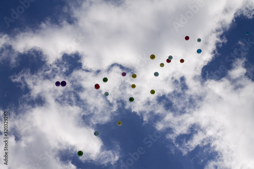 inflatable balloons in the sky released into the sky at graduation in school kindergarten. Multicolored inflatable balloons with helium flying in the sky