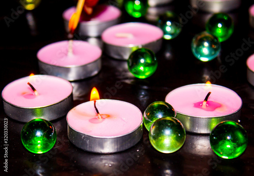 Candles and glass balls on a black background