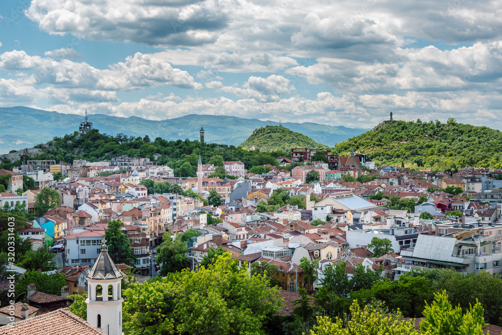 Panoramic view of the multicultural city of Plovdiv. In the front there is an  Orthodox church, in the center a mosque and in the background are the typical of Plovdiv hills. View from Nebet tepe hill