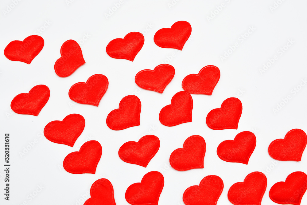 Red and white fabric hearts on a white background. Theme for Valentine's Day and holidays