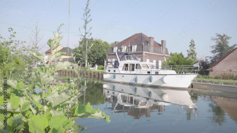 Nice little pleasure boat moored on Espierre Canal in Belgium Nice little pleasure boat moored on Espierre Canal in Belgium