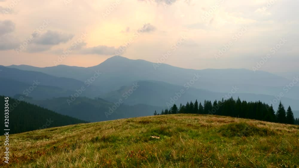 Scenic Panorama View On Top of the Mountain. Carpathian Mountains Peaks. Clouds Woods Meadows Grass Scenic Panorama View On Top of the Mountain. Carpathian Mountains Peaks. Clouds Woods Meadows Grass