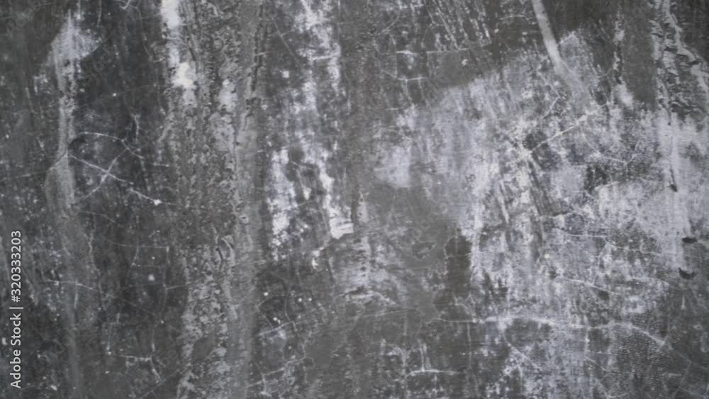 A close up shot of a scratched textured wall with black and white areas and cracks. Lots of grungy lines and patterns. Panning left. A close up shot of a scratched textured wall with black and white areas and cracks. Lots of grungy lines and patterns. Panning left.