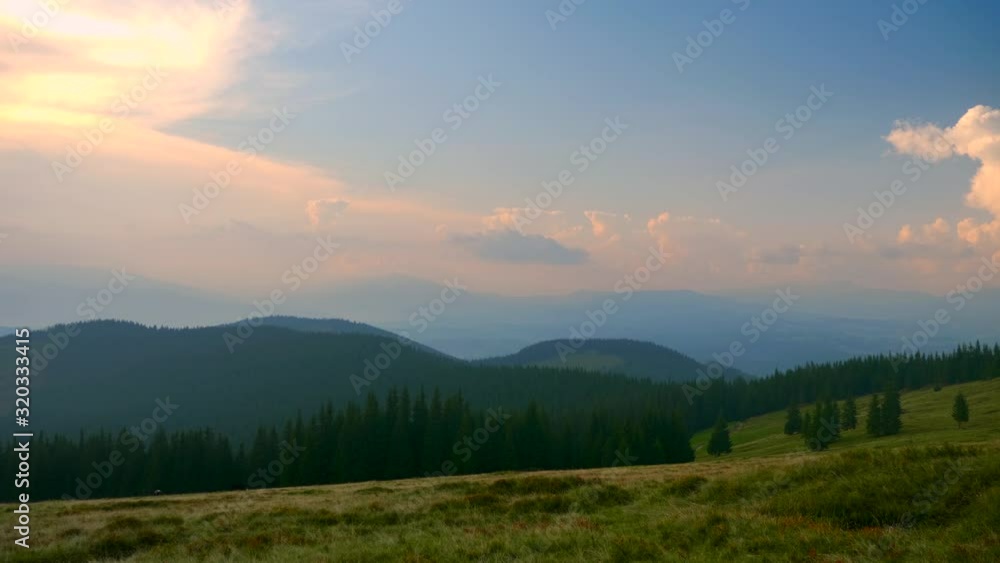 Scenic Panorama View On Top of the Mountain. Carpathian Mountains Peaks. Clouds Woods Meadows Grass Scenic Panorama View On Top of the Mountain. Carpathian Mountains Peaks. Clouds Woods Meadows Grass