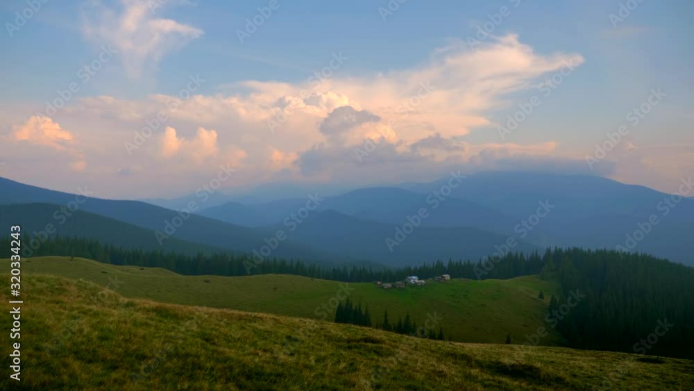 Scenic Panorama View On Top of the Mountain. Carpathian Mountains Peaks. Clouds Woods Meadows Grass Scenic Panorama View On Top of the Mountain. Carpathian Mountains Peaks. Clouds Woods Meadows Grass
