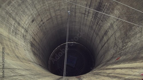 The hollow center of one of the Orlando power plant cooling towers viewed from the top. High angle, Pan left. Medium shot. photo