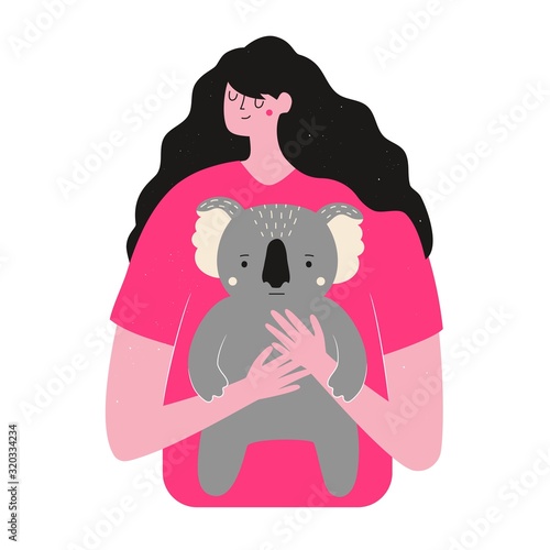 Long hair woman hugs koala. Rescue animals from fires in Australia.