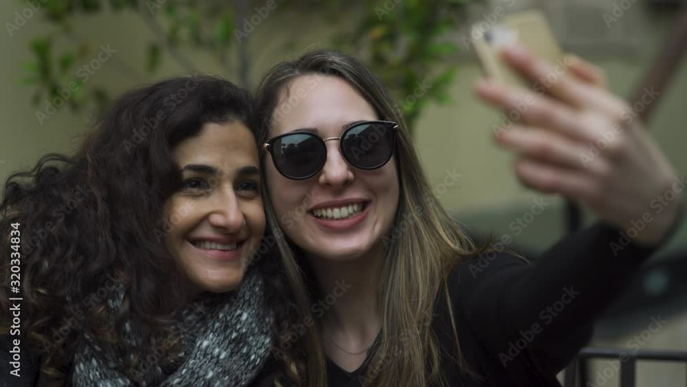 two young attractive women having fun, making silly duck faces and taking selfies on vacation. 4K two young attractive women having fun, making silly duck faces and taking selfies on vacation. 4K