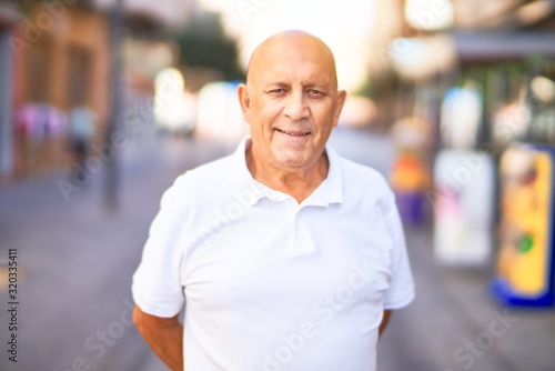 Senior handsome man smiling happy and confident. Standing with smile on face at town street