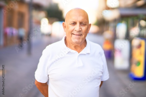 Senior handsome man smiling happy and confident. Standing with smile on face at town street © Krakenimages.com