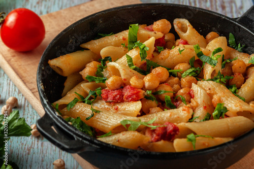 Italian pasta with chickpeas, spices and tomatoes - closeup