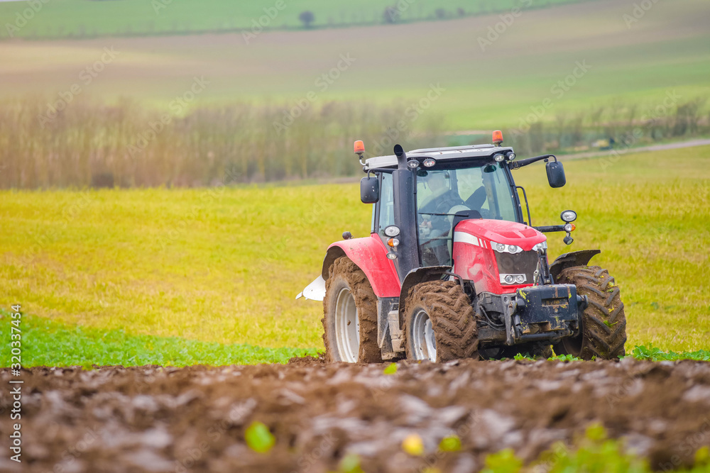 farmer plowing his fields in early spring farmer plowing his fields in early spring