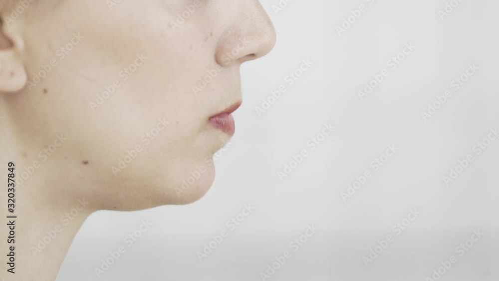 close up profile of blonde caucasian young girl with red lips chewing gum and blowing bubbles , hipster pop footage, close up profile of blonde caucasian young girl with red lips chewing gum and blowing bubbles , hipster pop footage,