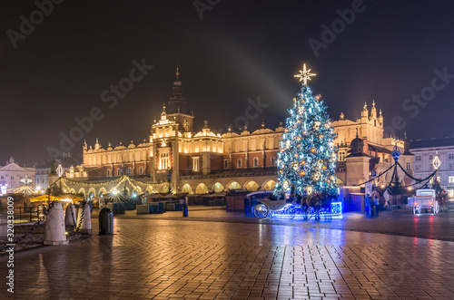 Krakow, Poland, Main Square and Cloth Hall in the winter season, during Christmas fairs decorated with Christmas tree.