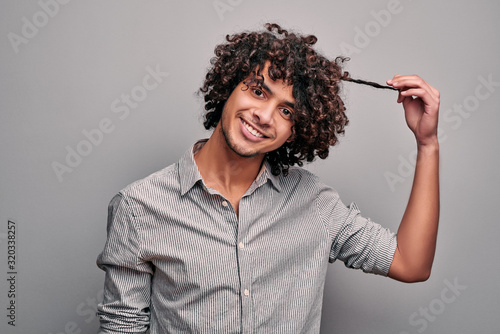 Canvas Print Arabian man shows his healthy beautiful curly hair