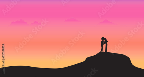Silhouette couple stand on mountain with sunset background