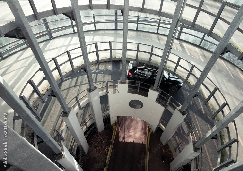 car leaves parking via concrete carousel in western part of amsterdam