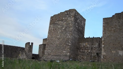 Doves in front of the entrance of the Inner town.  Low angle view of the towers of Smederevo fortress.Selective soft focus photo
