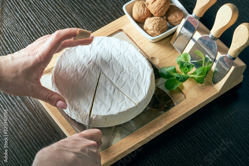 Photography Closeup on woman cutting fresh cheese