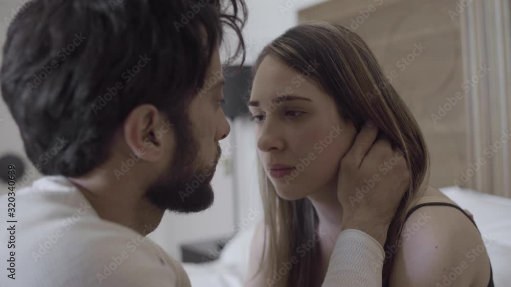 Close up of young attractive couple in love looking into each other's eyes almost kissing Close up of young attractive couple in love looking into each other's eyes almost kissing