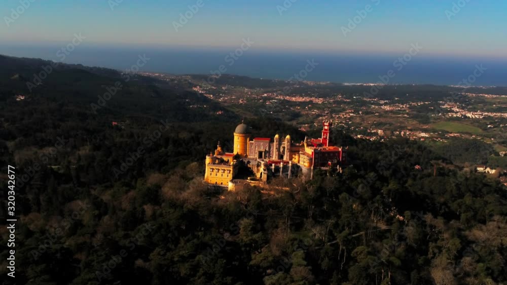 Aerial of sintra palacio da pena, a colorful palace on top of a hill in Portugal Aerial of sintra palacio da pena, a colorful palace on top of a hill in Portugal