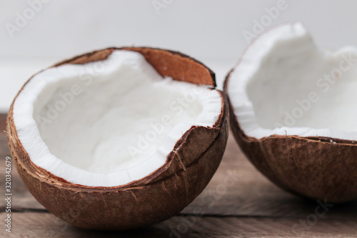 two halves of a coconut on a wooden table