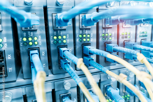 Fotografia Fiber Optic cables connected to optic ports and UTP, Network cables connected to