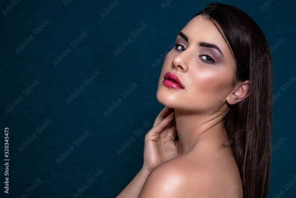 Brunette girl with long and shiny long hair and with perfect make-up on a blue background. Brunette girl with long and shiny long hair and with perfect make-up on a blue background.