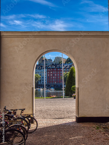 Archway with buildings and lake