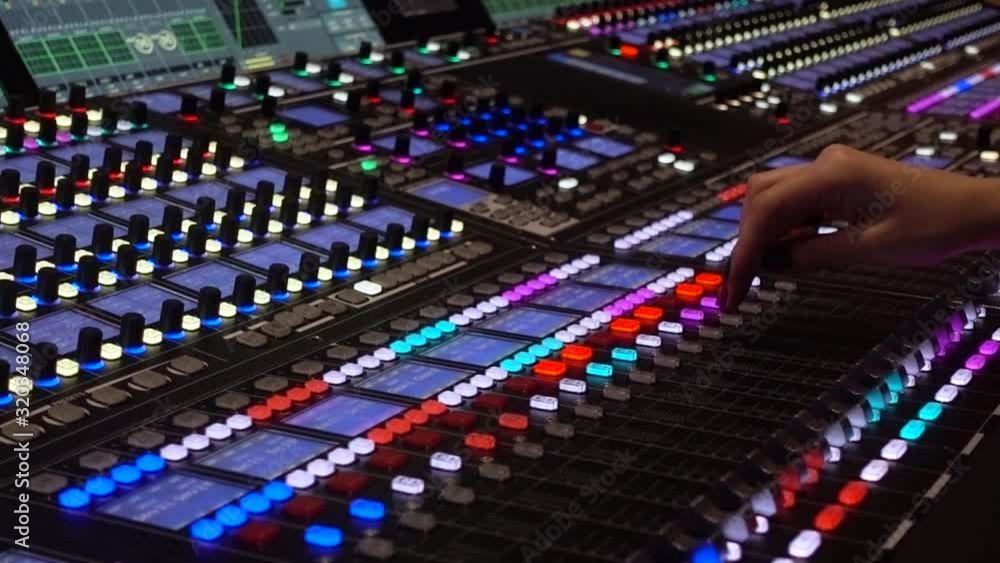 Professional tool sound engineer in the studio or at a concert. Telecommunication. Musical digital mixer to adjust the scene close-up. Hand woman Professional tool sound engineer in the studio or at a concert. Telecommunication. Musical digital mixer to adjust the scene close-up. Hand woman