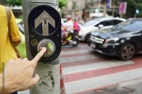 Pedestrian  pushing the button at the pedestrian crossing