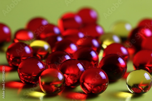 transparent colored capsules on a yellow background