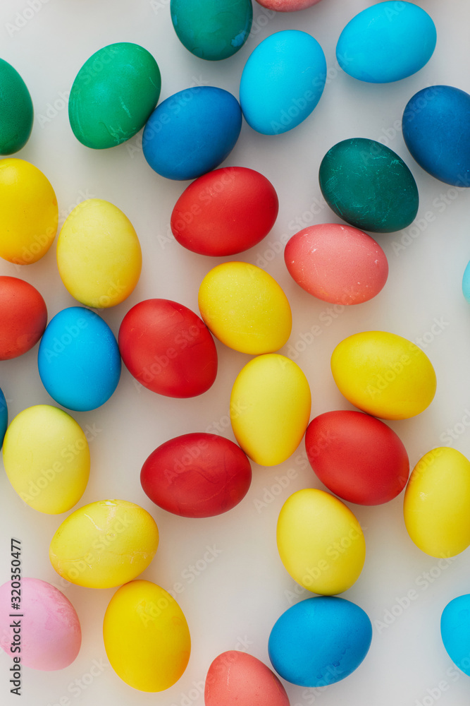 Above view of pastel colored Easter eggs arraigned in minimal composition on white background, copy space Above view of pastel colored Easter eggs arraigned in minimal composition on white background, copy space