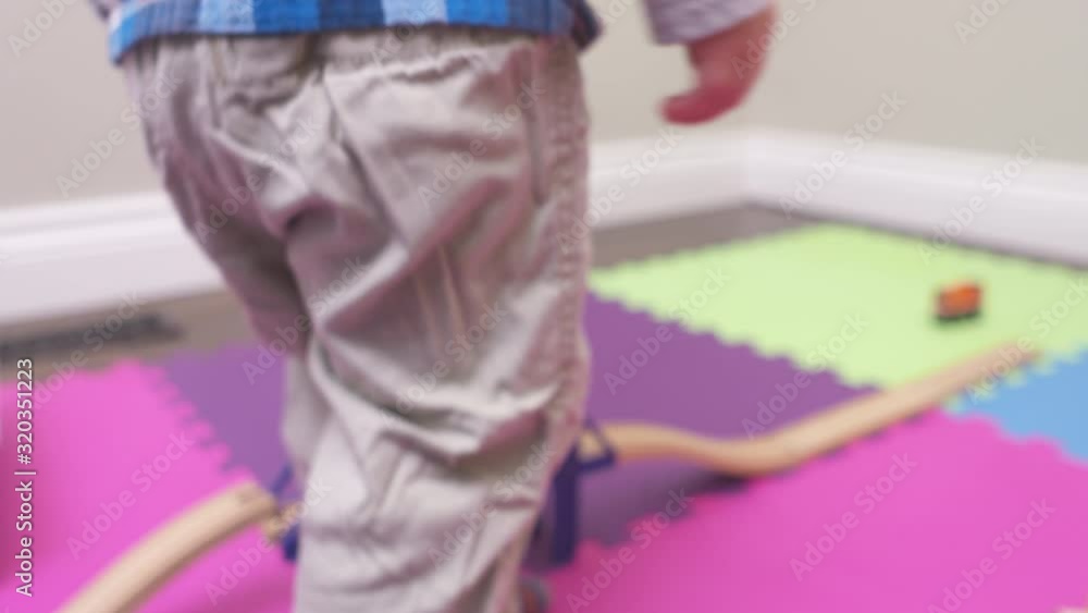Toddler boy throws a toy in his playroom. Toddler boy throws a toy in his playroom.
