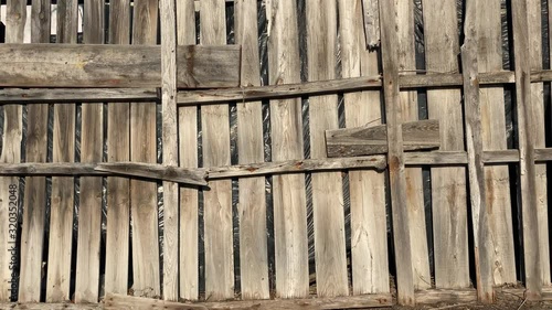 Dirty damaged wooden fence in the village
